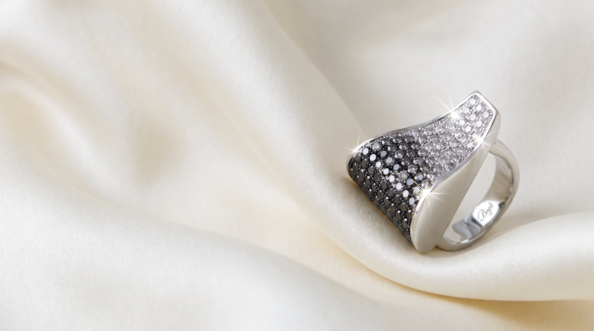 Diamond ring resting on ivory silk