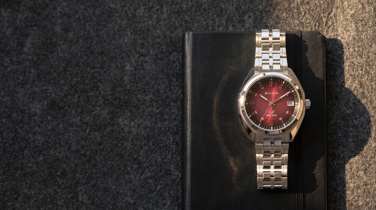 Bulova Jet Star with a red dial on a black leather notebook