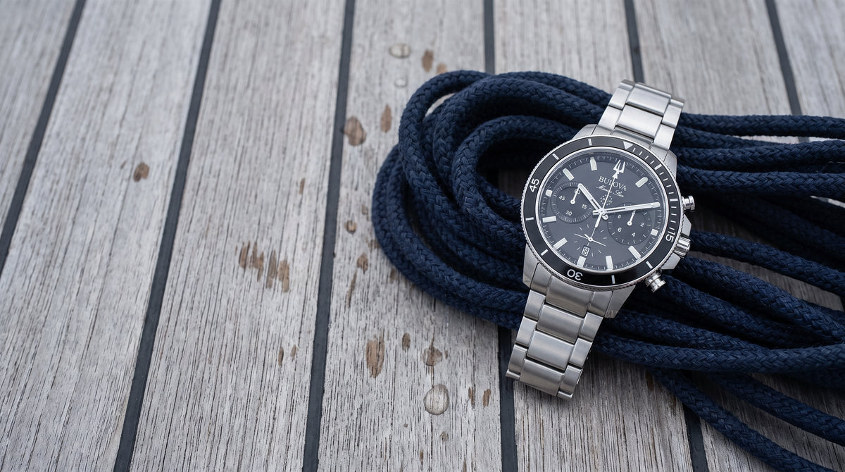 Bulova Marine Star chronograph on a coil of navy rope on a teak deck