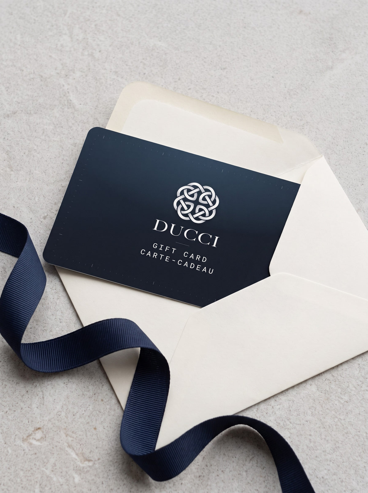 Ducci gift card with an envelope and navy ribbon
