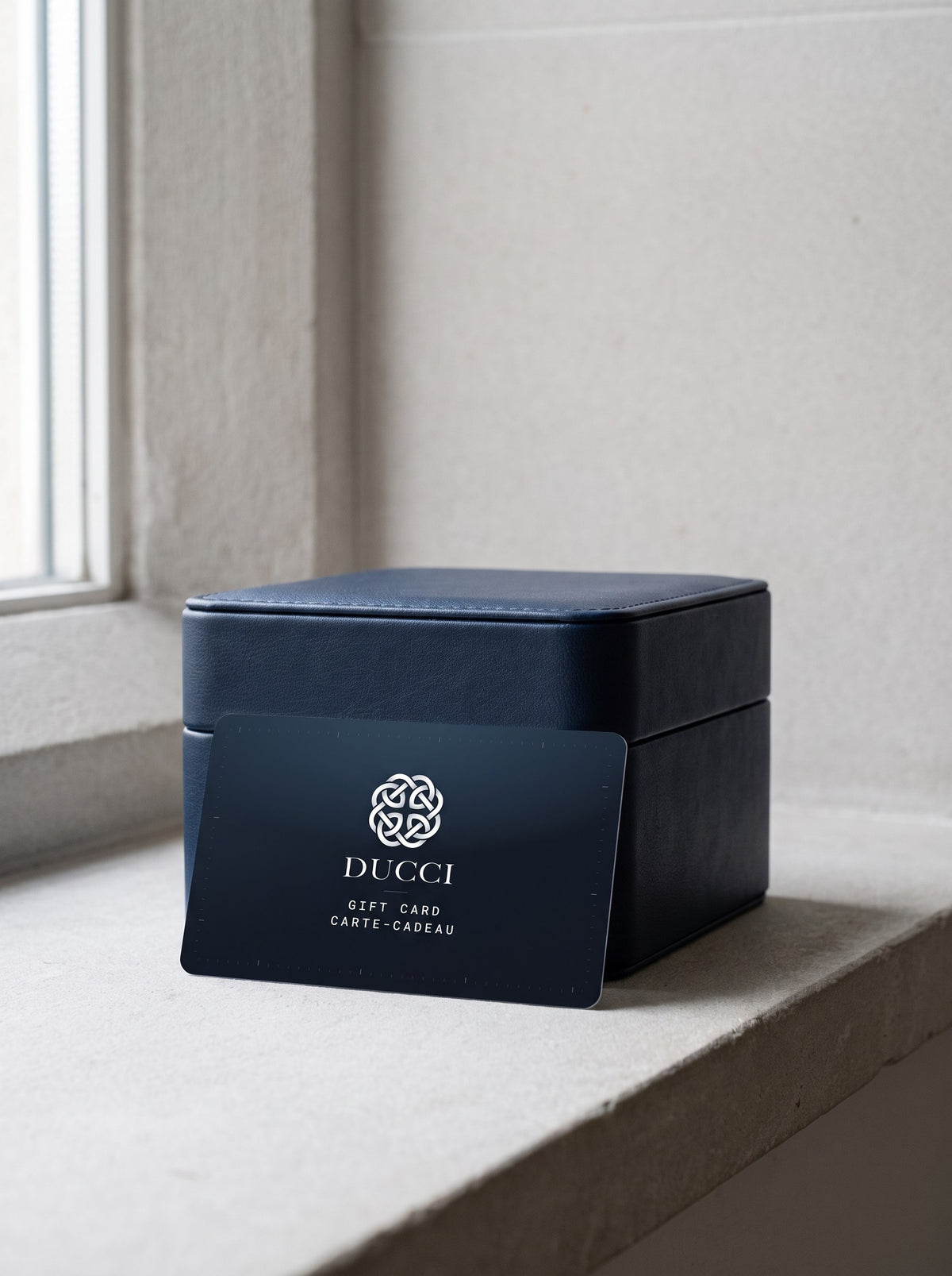 Ducci gift card leaning on a watch box